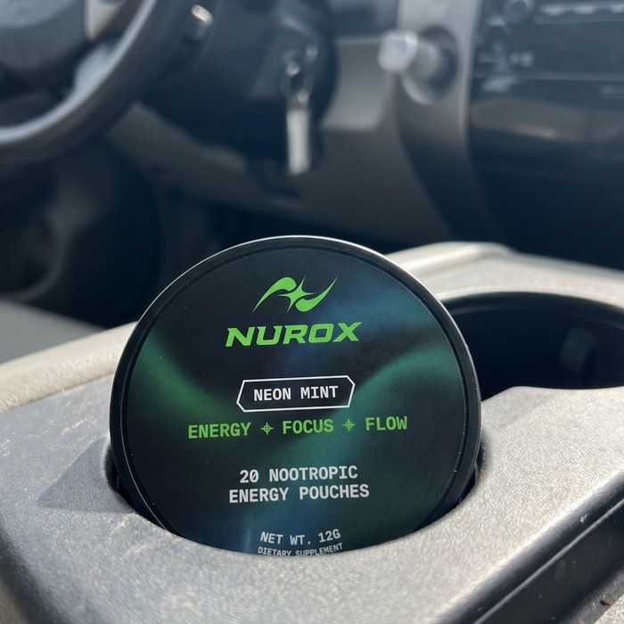 NUROX tin in a car cup holder